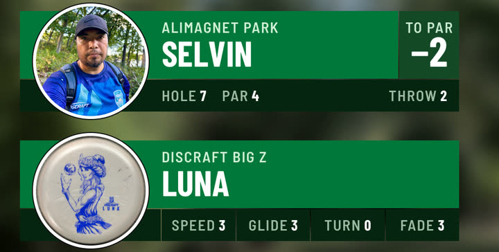 The throw overlay with Selvin’s photo and the disc overlay with a photo of a white Big Z Luna, both as round die-cut stickers, in Forest, over blurred footage from Alimagnet Park.